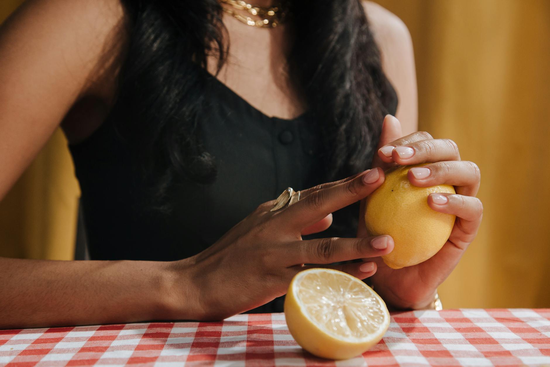Intimate close-up of hands holding a sleek blue vibrator against a purple background