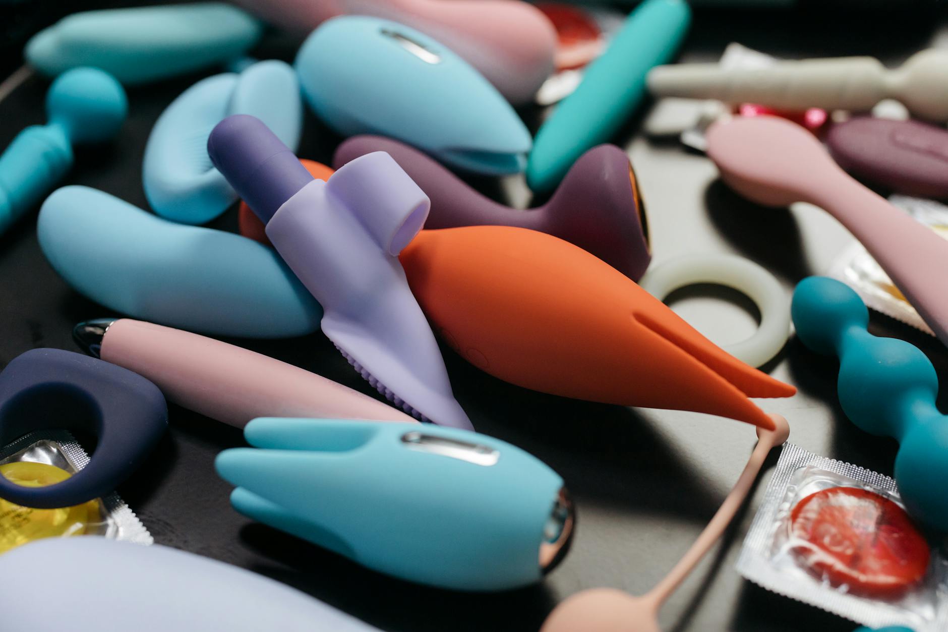 Array of colorful vibrators in close-up, symbolizing tools for reconnecting with pleasure
